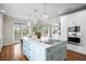 Spacious kitchen island boasts a cooktop and bar seating, offering a seamless cooking and dining experience at 5004 W Leona St, Tampa, FL 33629