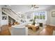 Bright living room with white furniture, hardwood floors, and a large window offering natural light at 5004 W Leona St, Tampa, FL 33629
