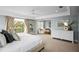 Bright and airy main bedroom featuring private balcony, sitting area, and neutral color palette at 5004 W Leona St, Tampa, FL 33629