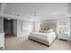 Spacious main bedroom featuring tray ceilings, plush carpet, and natural light at 5004 W Leona St, Tampa, FL 33629