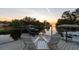Relaxing outdoor deck with chairs, overlooking a serene waterfront at sunset at 5004 W Leona St, Tampa, FL 33629