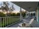 Relaxing front porch with seating area and view of backyard at 5004 W Leona St, Tampa, FL 33629
