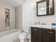 Updated bathroom with a shower/tub combo and dark vanity at 5013 Terrace Palms Cir # 101, Tampa, FL 33617