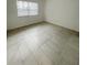 Spacious bedroom with tile flooring and large window at 5013 Terrace Palms Cir # 101, Tampa, FL 33617