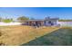 Spacious backyard featuring a large grassy area and screened patio at 5201 40Th S St, St Petersburg, FL 33711