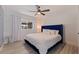 Bright bedroom with a king-size bed and blue velvet headboard at 5201 40Th S St, St Petersburg, FL 33711