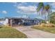 Mid-century modern home with updated facade, carport, and landscaped yard at 5201 40Th S St, St Petersburg, FL 33711