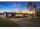 Mid-century modern home with updated facade, carport, and landscaped yard at 5201 40Th S St, St Petersburg, FL 33711