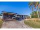 Mid-century modern home with updated facade, carport, and landscaped yard at 5201 40Th S St, St Petersburg, FL 33711