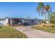 Updated mid-century home featuring a modern facade and driveway at 5201 40Th S St, St Petersburg, FL 33711