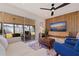 Living room features a large TV, comfy seating, and sliding glass doors at 5201 40Th S St, St Petersburg, FL 33711