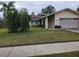 Single-story house with a two-car garage and mature landscaping at 604 Sandalwood Dr, Plant City, FL 33563