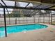 Screened pool and patio area with covered lanai at 604 Sandalwood Dr, Plant City, FL 33563