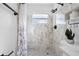 Modern bathroom with marble shower, stylish vanity, and updated fixtures at 7103 Landmark Dr, Spring Hill, FL 34606