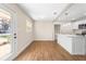 Open concept dining area with hardwood floors and kitchen island at 712 E Madison St, Plant City, FL 33563