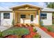 Newly renovated home with a charming front porch and well-manicured landscaping at 712 E Madison St, Plant City, FL 33563