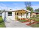 Cozy one-story house featuring a covered porch and inviting curb appeal at 712 E Madison St, Plant City, FL 33563