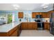 Modern kitchen with stainless steel appliances and wood cabinets at 8010 Larriott Dr, Largo, FL 33773