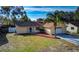 Single-story house with a paved driveway and palm tree at 8620 Horizon Ln, Hudson, FL 34667