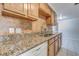 Modern kitchen with granite countertops and wood cabinets at 8620 Horizon Ln, Hudson, FL 34667