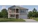 Two-story home with blue and brown siding, balcony, and two-car garage at 11691 E 74Th Cir, Palmetto, FL 34221