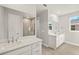 Bathroom with double vanity, stone countertops, and a glass shower at 11971 Starbright Path, Venice, FL 34293