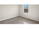 Bright bedroom with plush carpeting and a window offering natural light at 11971 Starbright Path, Venice, FL 34293