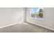 Bright bedroom featuring large window and carpet at 11971 Starbright Path, Venice, FL 34293