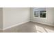 Bright bedroom with large window and tile flooring at 11971 Starbright Path, Venice, FL 34293
