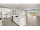 Modern kitchen featuring stainless steel appliances, a center island, and sliding doors to the outside at 11971 Starbright Path, Venice, FL 34293