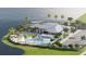 An aerial view of the community clubhouse with resort-style pool, palm trees, and lakeside views at 11971 Starbright Path, Venice, FL 34293