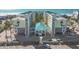 Aerial view of a beachside condo building with parking and ocean views at 12000 Gulf Blvd # 208-S, Treasure Island, FL 33706