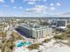 Aerial view of a condo building near the beach with a pool at 12000 Gulf Blvd # 208-S, Treasure Island, FL 33706