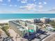 Aerial of beachfront resort, pool, and ocean at 12000 Gulf Blvd # 208-S, Treasure Island, FL 33706