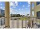 Private balcony overlooking the parking lot and partial ocean view at 12000 Gulf Blvd # 208-S, Treasure Island, FL 33706