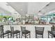 Community bar with seating and fully stocked shelves at 12000 Gulf Blvd # 208-S, Treasure Island, FL 33706