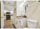 Small bathroom with granite vanity, toilet and view of kitchen at 12000 Gulf Blvd # 208-S, Treasure Island, FL 33706