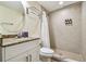 Bathroom with granite vanity, shower and tile flooring at 12000 Gulf Blvd # 208-S, Treasure Island, FL 33706