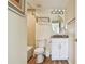 Bathroom with neutral tiles and vanity with white cabinets and decorative brown countertop at 12000 Gulf Blvd # 208-S, Treasure Island, FL 33706