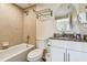 Bathroom featuring bathtub and shower with neutral tiles and vanity with white cabinets and brown countertop at 12000 Gulf Blvd # 208-S, Treasure Island, FL 33706