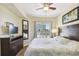 King-size bed, hardwood floors, and sliding glass doors to balcony at 12000 Gulf Blvd # 208-S, Treasure Island, FL 33706