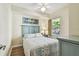 Light and airy bedroom with palm tree art above the bed at 12000 Gulf Blvd # 208-S, Treasure Island, FL 33706