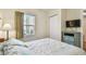 Bright bedroom featuring a comfy bed, colorful accents, and a window with outdoor views at 12000 Gulf Blvd # 208-S, Treasure Island, FL 33706