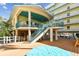 Two-story community building with a deck and stairs at 12000 Gulf Blvd # 208-S, Treasure Island, FL 33706
