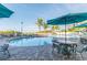 Relaxing pool area with patio tables and umbrellas at 12000 Gulf Blvd # 208-S, Treasure Island, FL 33706
