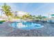 Resort-style pool with lounge chairs and umbrellas at 12000 Gulf Blvd # 208-S, Treasure Island, FL 33706