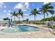 Refreshing community pool with palm trees and seating at 12000 Gulf Blvd # 208-S, Treasure Island, FL 33706