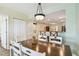 Dining area with wood table and white chairs, open to kitchen at 12000 Gulf Blvd # 208-S, Treasure Island, FL 33706