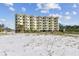 Condo building on the beach, yellow exterior, multiple stories at 12000 Gulf Blvd # 208-S, Treasure Island, FL 33706