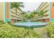 Serene courtyard features a charming fountain amidst tropical landscaping for a relaxing atmosphere at 12000 Gulf Blvd # 208-S, Treasure Island, FL 33706